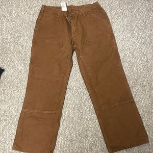 Woman’s Carhartt work pants.